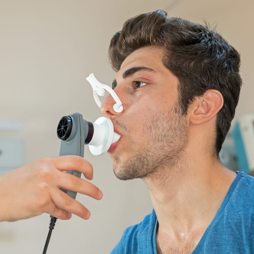 Doctor reviews patient's lung capacity with a peak flow meter