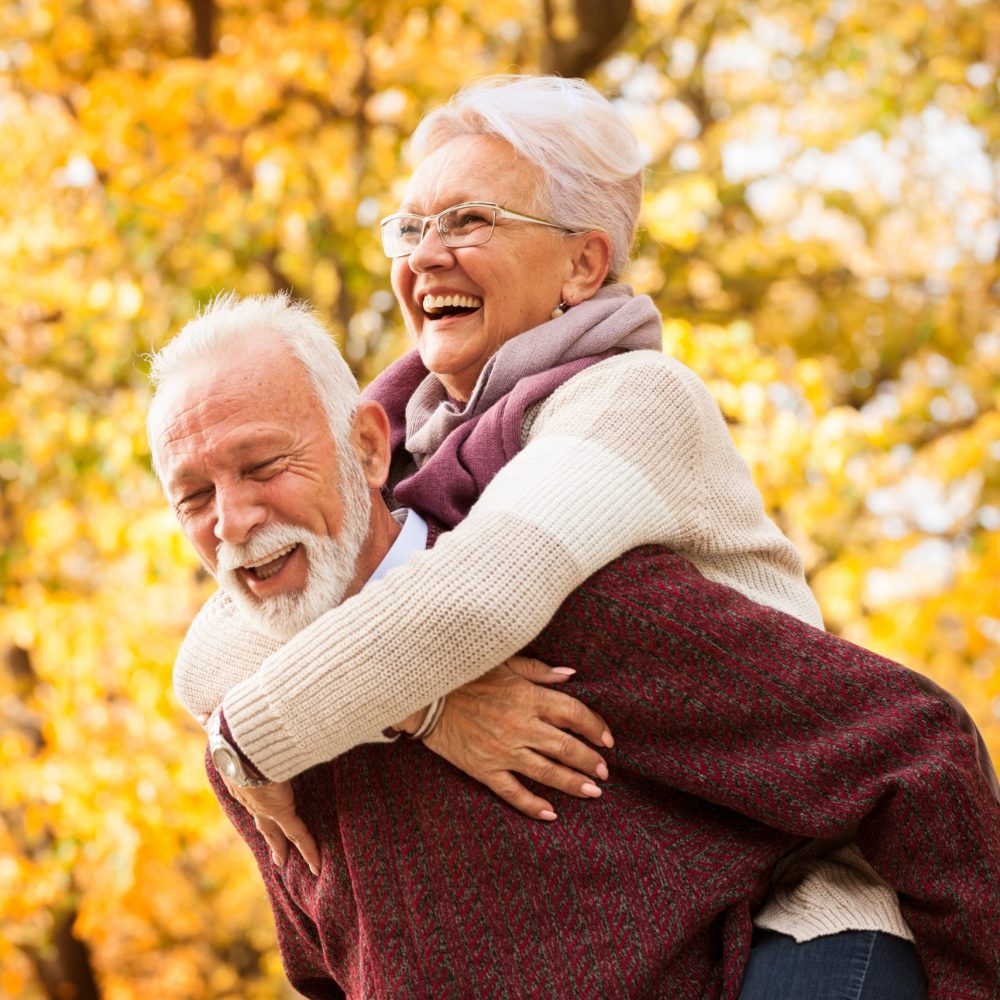 Senior couple embrace outside