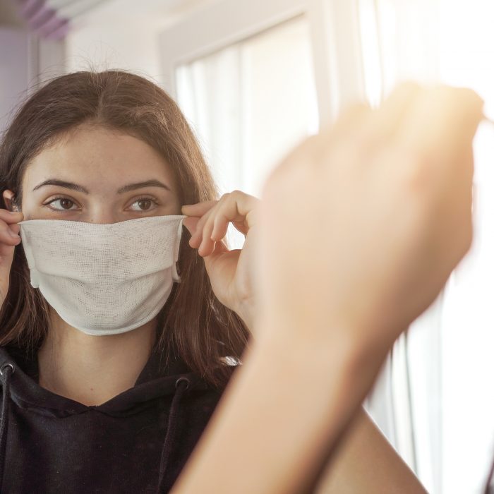 Young woman trying on a face mask