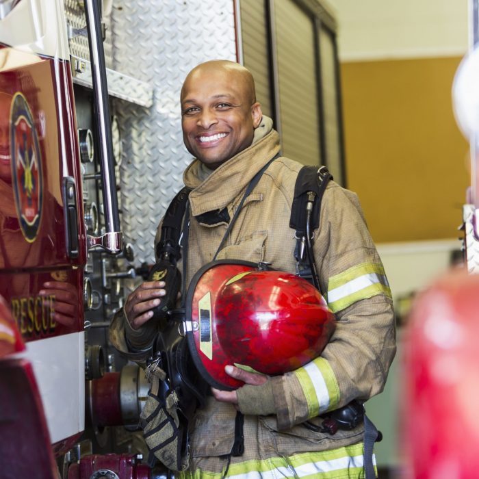 fire fighter standing next to truck