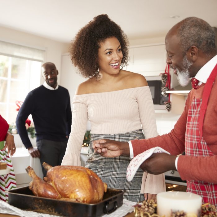 Older family making turkey dinner