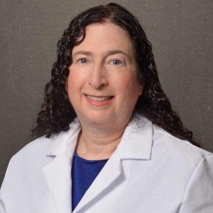 female physician with curly brown hair
