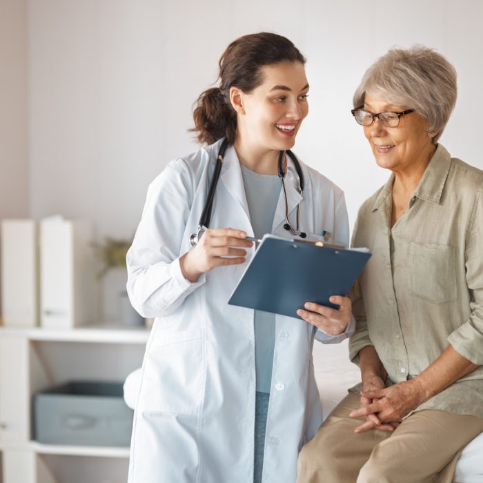 Female patient listening to a doctor in hospital.