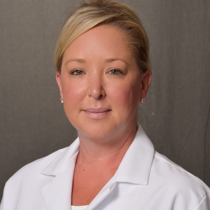 blonde woman in white lab coat