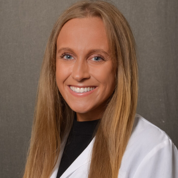 woman with long blonde hair in lab coat