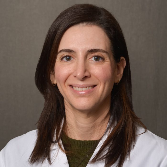 female nurse practitioner with shoulder length dark brown hair