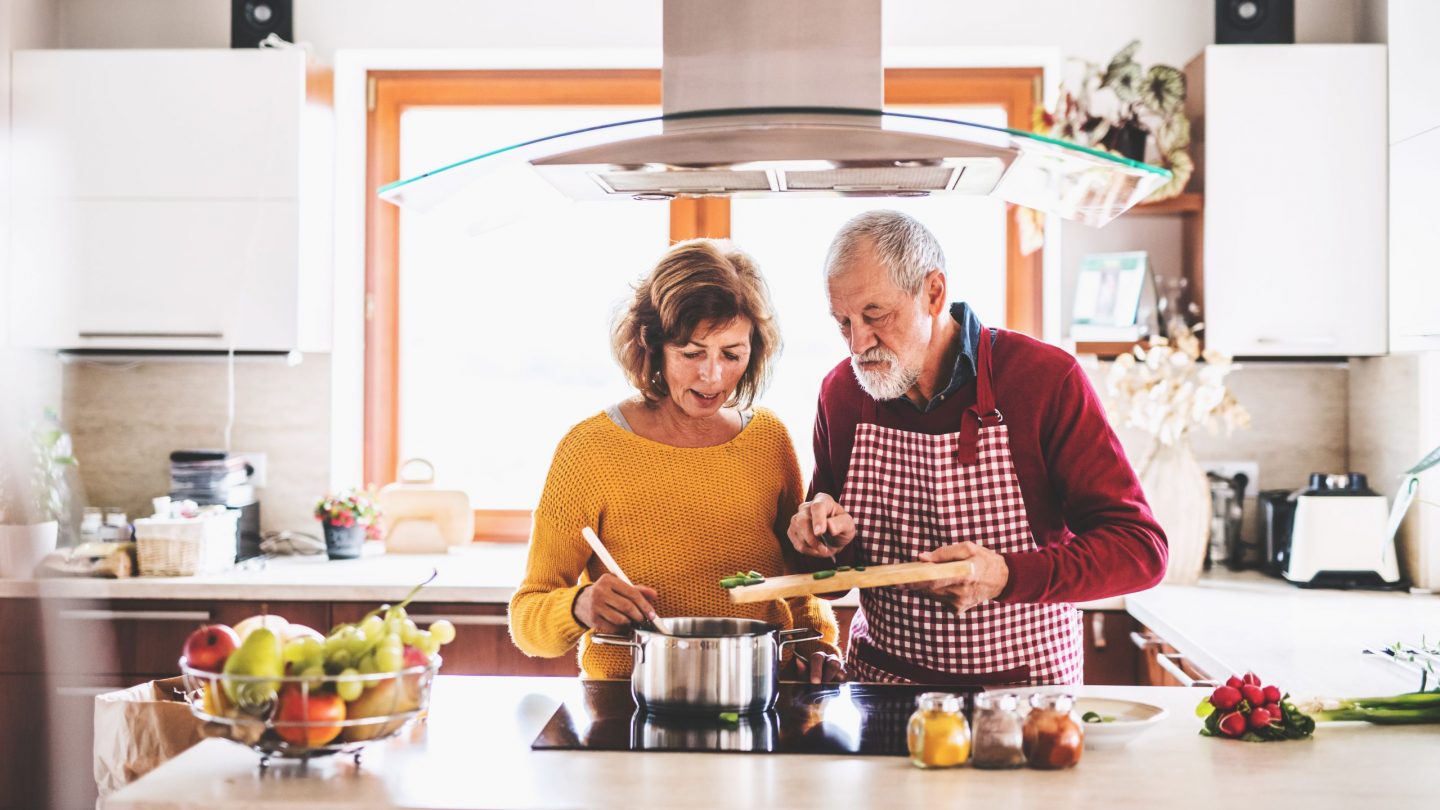 Senior couple preparing food in the kitchen.