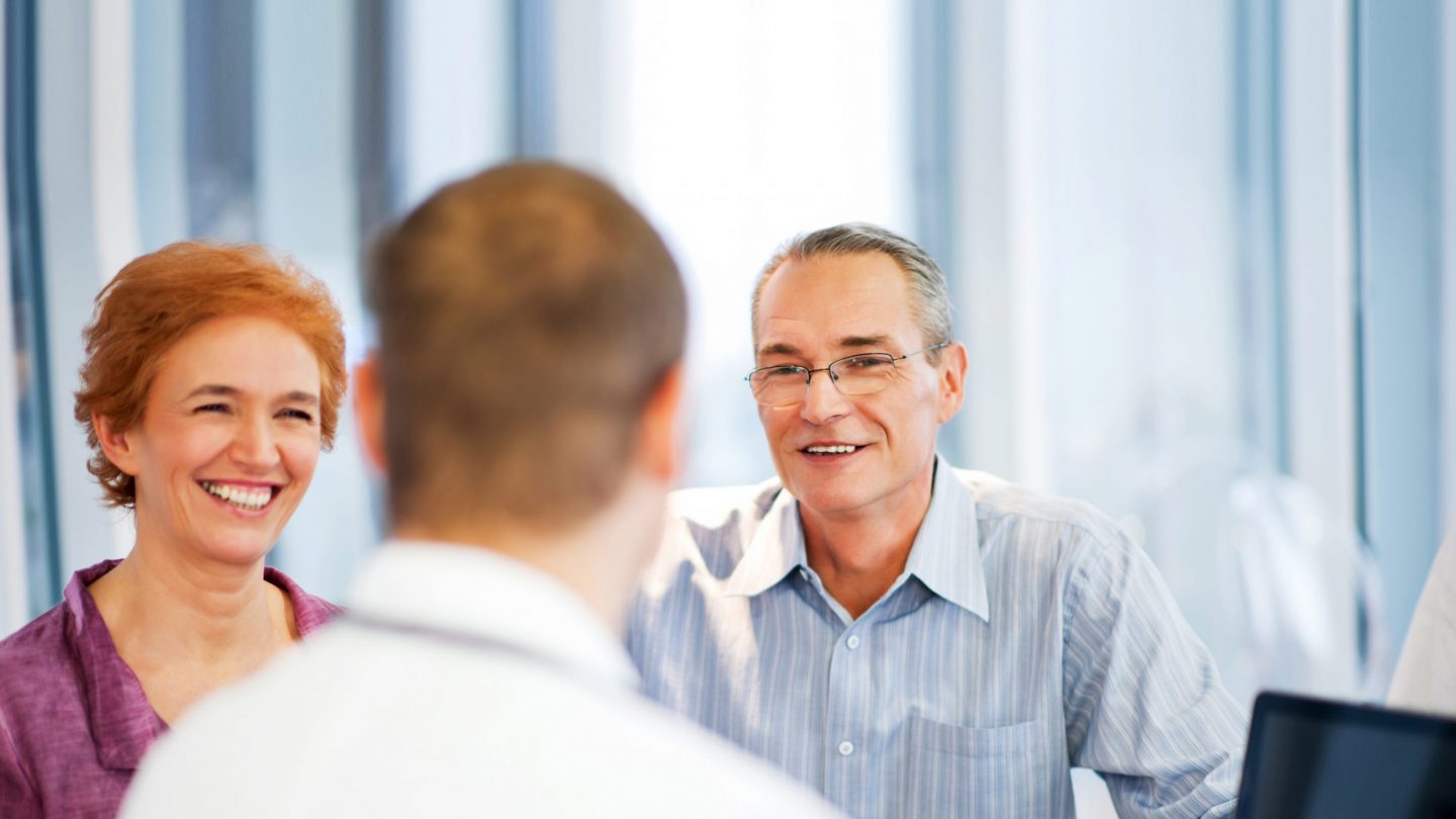 Couple speaking with doctor