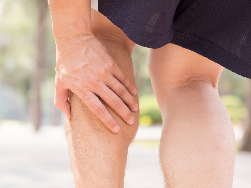 Cramp in leg while exercising. Sports injury concept