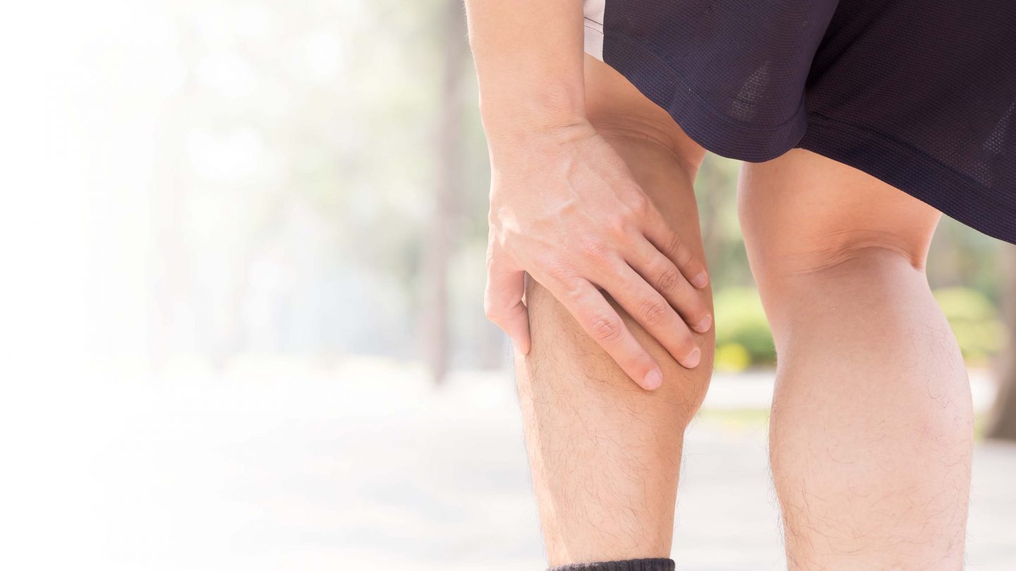 Man grabbing calf