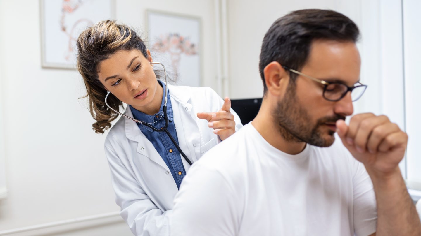 Female primary care physician with patient
