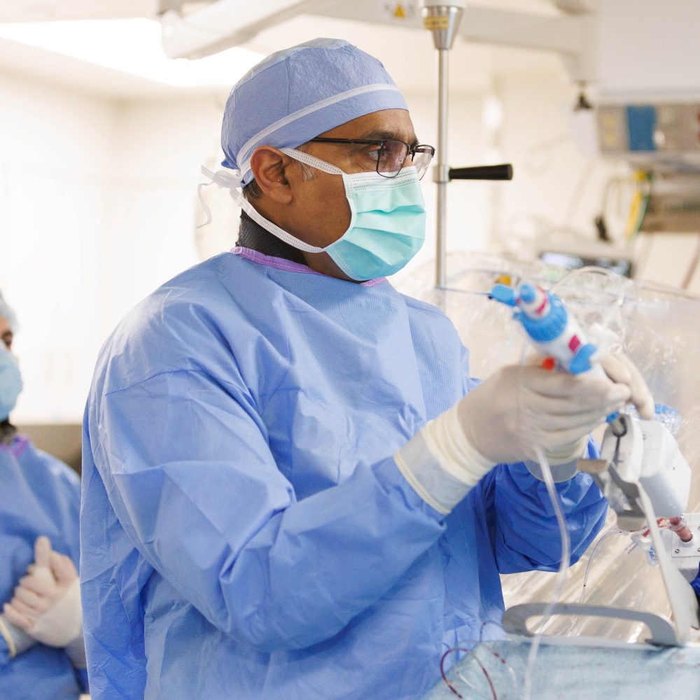 physician performing valve replacement surgery